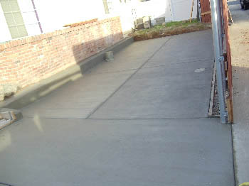 Uniform broom finish concrete driveway with clean expansion joints in Sacramento, CA