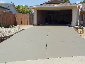 Reinforced concrete driveway installation with stamped border in Sacramento, CA.